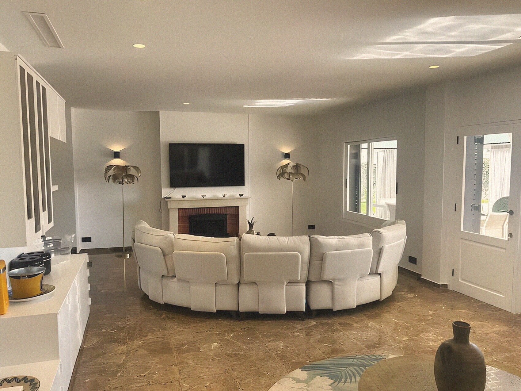 The living room with fireplace and curved sofa